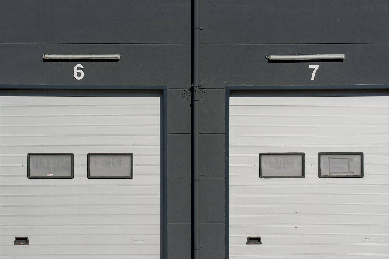 Close-up of modern garage doors numbered 6 and 7 on an industrial building facade.