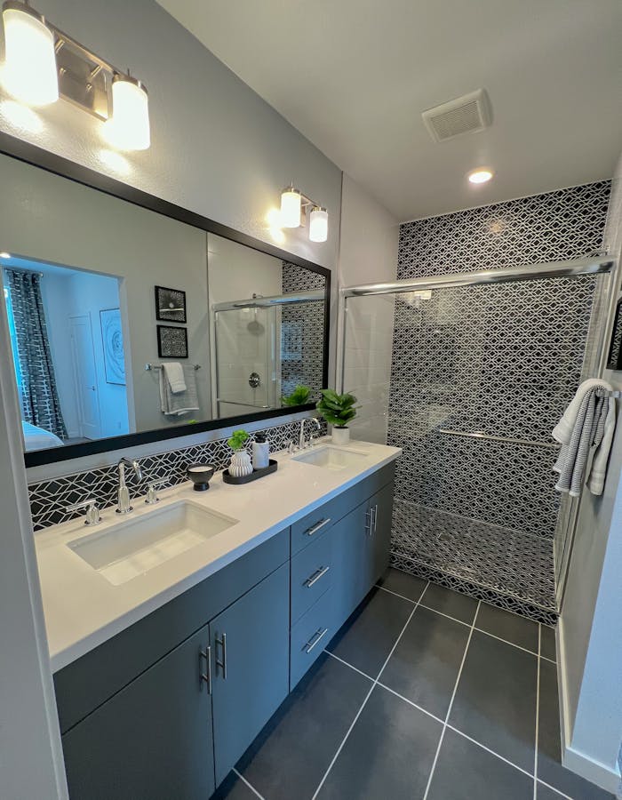 Contemporary bathroom showcasing sleek design with sink and shower area.