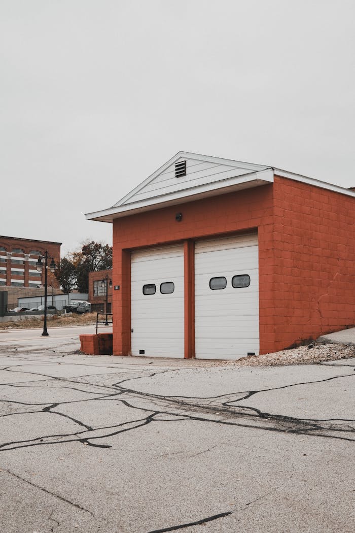 Technician performing automatic garage door repair, fixing motorized opener system for smooth and reliable door operation.