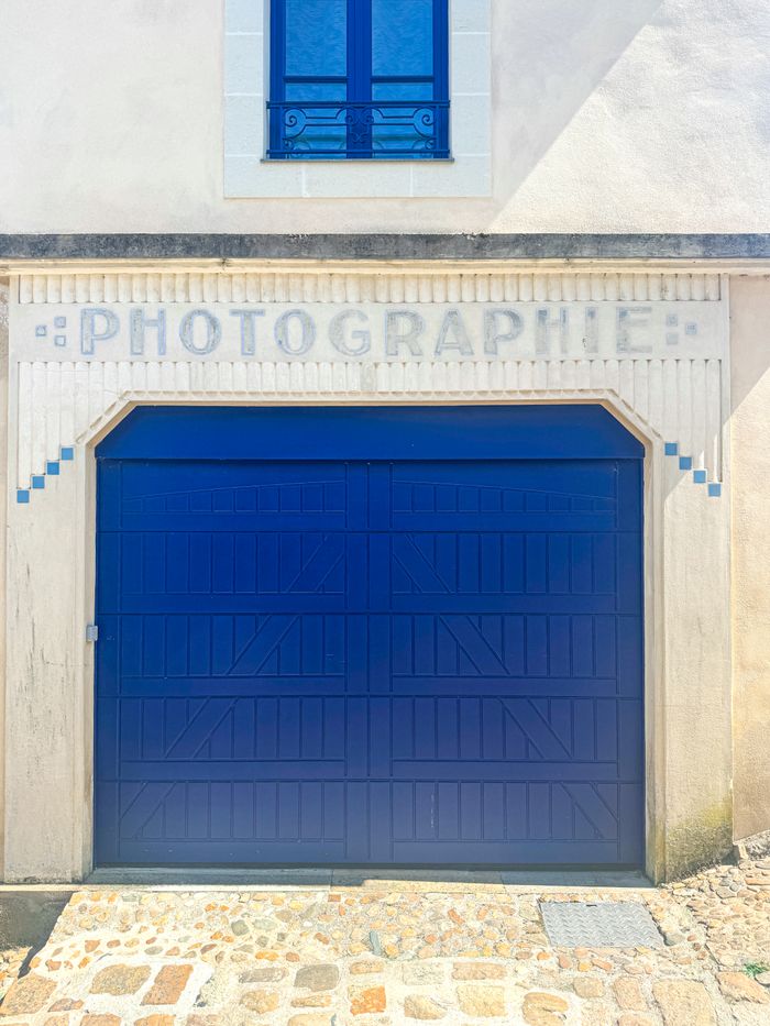 Charming shopfront with blue doors and 'PHOTOGRAPHIE' sign in Château-Gontier, France.