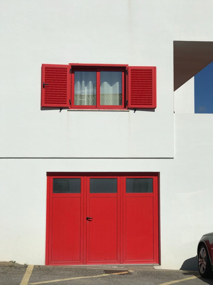 services-02 Minimalist facade featuring red door and window, perfect for architecture photos.