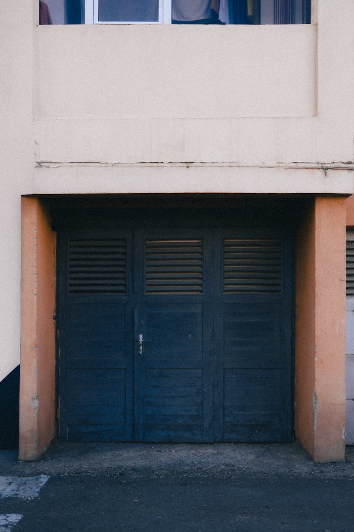 Closed garage door in an urban residential building exterior.